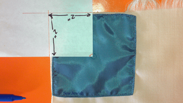 Where to put tzitzit hole on tallit