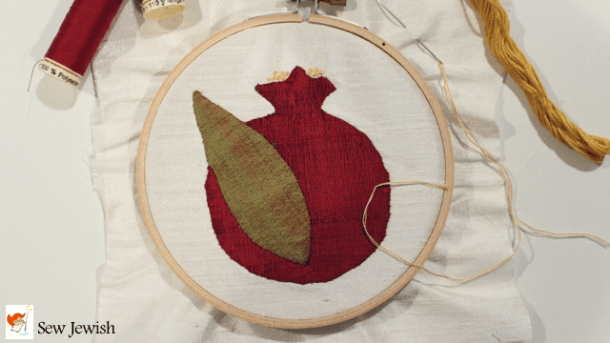 Hand appliqued silk pomegranate with French knot stamens