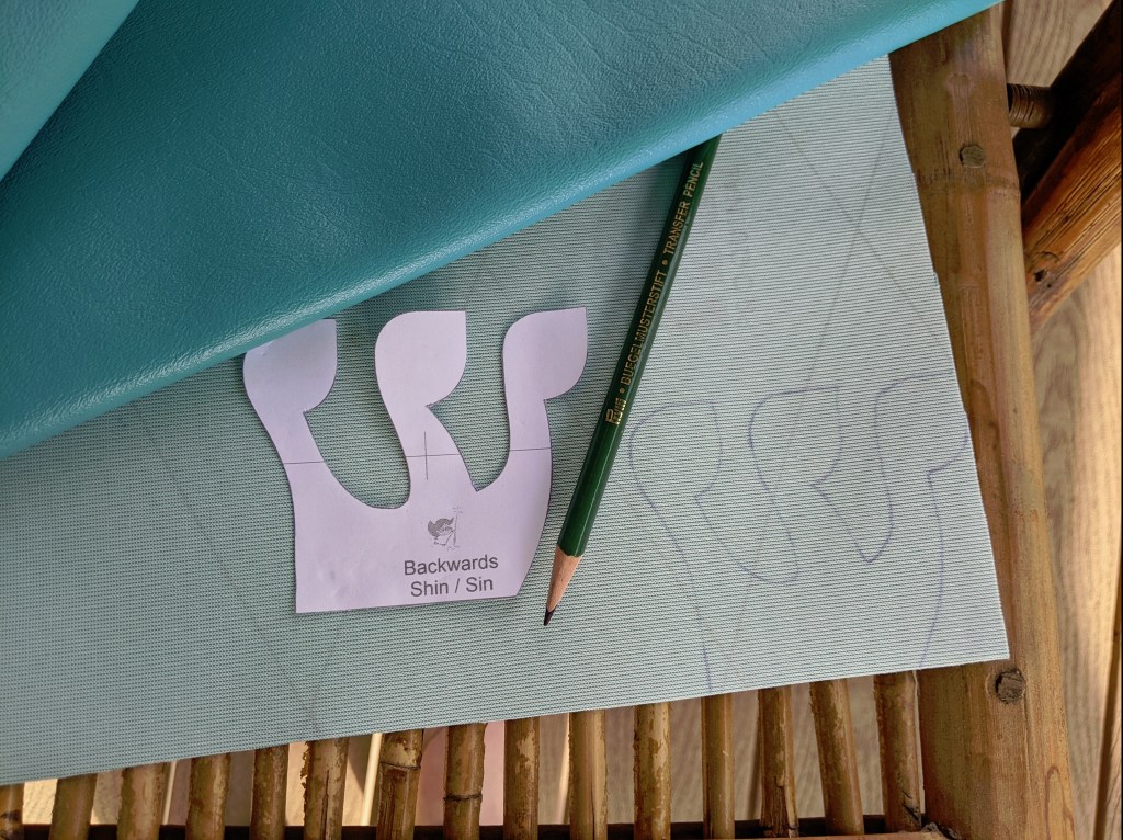 Trace backwards monogram on back of fabric