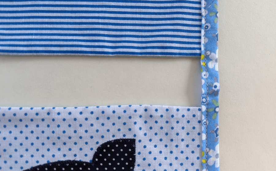 Stitch along string close to inner folded edge